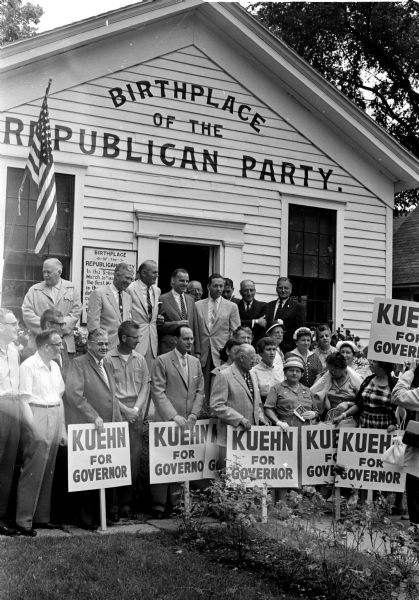 Republican candidates for state office started a week-long campaign at the Little White Schoolhouse in Ripon, the birthplace of the GOP in 1854. Standing on the platform, second from left, is Warren Knowles, candidate for lieutenant governor. At Knowles' left, in order, are Robert Zimmerman, running for reelection as secretary of state; Philip Kuehn, GOP gubernatorial candidate; and Ivan Kindschi, state treasurer candidate. The attorney general candidate, George Thompson, arrived after the portrait was taken. Standing at the extreme right of the schoolhouse stoop is Rep. William K. Van Pelt (R-Fond du Lac).