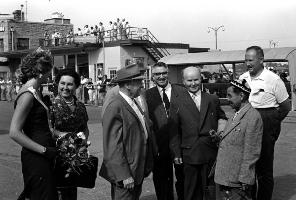 Russian delegates to the seventh International Soil Science Congress are greeted at Truax Municipal Airport. Ann Borland (left), Miss Madison, greets Mrs. E.D. Lebedina. At the right is Emil Truog, University of Wisconsin emeritus soil professor and congress manager; he is greeting S.A. Wilde (hidden), G.S. Davitjan (center), and Professor T.V. Tjuryn.