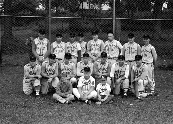Outdoor group portrait of the Waunakee baseball team, winners of the Northern section title of the Home Talent League.