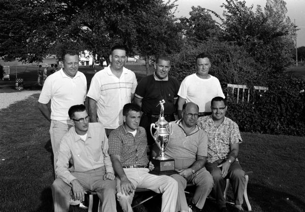 Group portrait of the prize winners at the Wisconsin Policeman's Protective Association's golf tournament at the Lake Ripley Country Club in Cambridge. Seated are members of the Racine team that won team honors, left to right, Joe Kozenski, Ralph Ferraro, Tom Koetting, and George Povtovich. Individual winners in back, left to right, are Les Martin, Kenosha; Melvin F. Wendt, Watertown; Henry Peters, West Milwaukee; and Ken Hartwich, Madison.