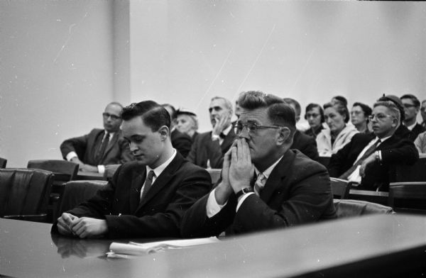 Jon (Mickey) Hayes, left, sitting at a table during the first day of his double-murder trail for killing his father and another man. Shown with his attorney, John L. Riley, in Circuit Court, the 20 year-old Hayes has made an "innocent because of insanity" plea before Circuit Judge Russell Hanson.