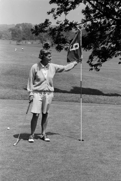 Pauline Erickson, city golf champion, wearing the popular free-action shirt, smooth shorts, and a matching alpaca sweater.