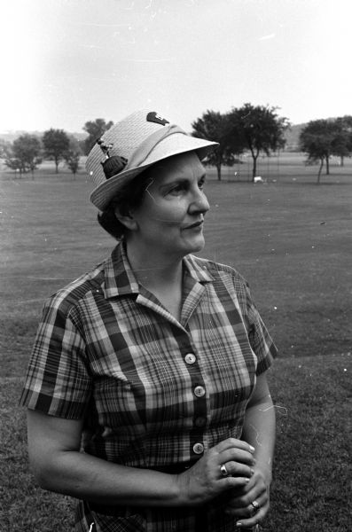 Margorie Hagan modeling a decorated straw hat and a plaid blouse.