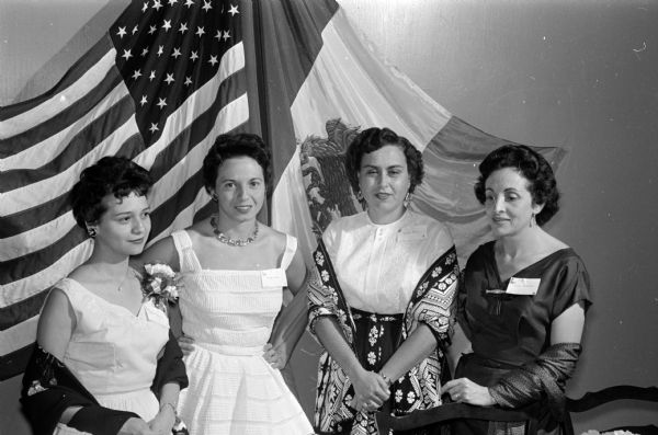People from Mexico living in the Madison area gather along with their American friends at the Truax Field Officer's Club to celebrate Mexico's Independence Day. Shown (left to right) are Mrs. Richard Amundson, Stoughton; Mrs. Wayne Eades, Madison; Mrs. Noe Neaves, Madison; and Mrs. Gustavo del Castillo, Madison.