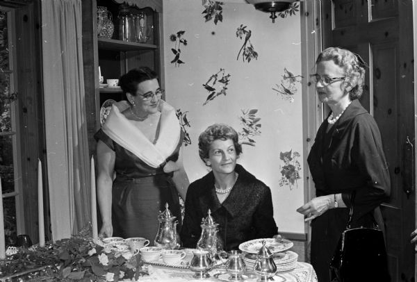 Eleanor Nerdrum (left), is hostess for a tea, the first invitational social event sponsored by the Women's Architectural League of Madison. She is shown with Wilma Sites, center, and Mrs. Arthur Waterman, Ft. Atkinson.