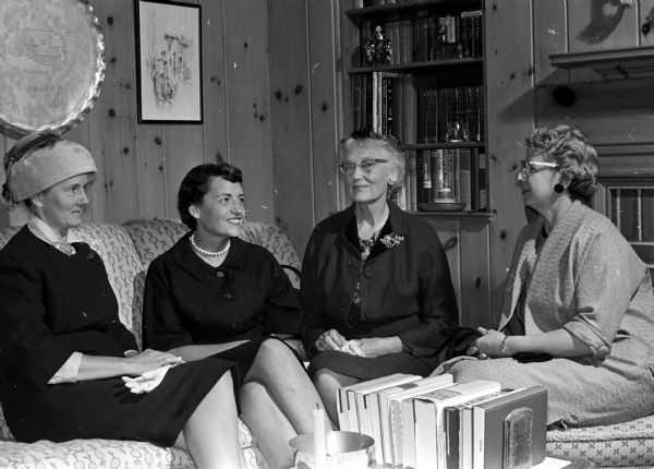 Mrs. Carl Shubert (left), La Crosse; Mrs. John Steinmann, Monticello; Juanita Potter; and Francis Weiler attend the first invitational social event sponsored by the Women's Architectural League of Madison. They are seated near the fireplace of the Stanley & Eleanor Nerdrum home.