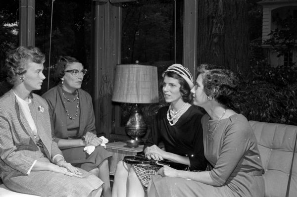Four board members of the Women's Architectural League of Madison sitting on the porch during an invitational tea for spouses of architects. From left to right are Ann Nugent, Mary Woehrl, Jean Potter, and Virginia Sample.
