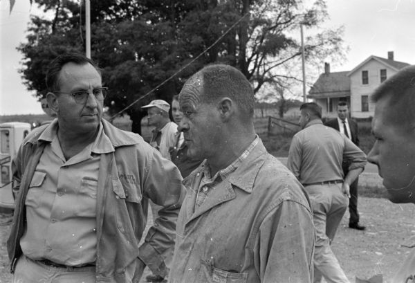 Carroll Kellor, right, talks to Oregon Fire Chief Norman Champion after escaping from the rubble of his explosion-wrecked store on Highway 14 (Oregon Road) in the Lakeview district 8 miles south of Madison. Kellor was treated for head burns and bruises.