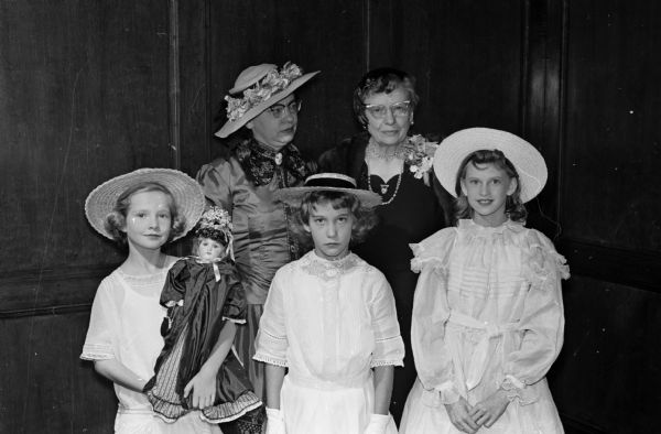 Mildred Horne, the new president of the Wisconsin Federation of Women's Clubs, was honored with a surprise "This is Your Life" program at a recent meeting of the Madison Woman's Club. Mildred Horne, standing at right in the second row, is shown with her daughter, Jane McBurney; Nancy Camp; Susan McBurney, a granddaughter; and Linda Mickow, who wore costumes reminiscent of Horne's childhood.