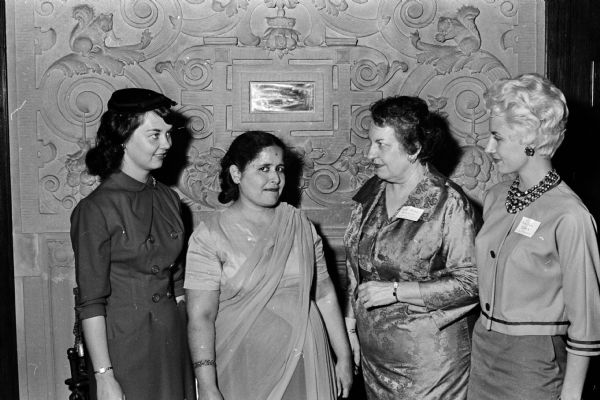 The Junior Division of the University of Wisconsn University League hosts a membership tea at the U.W. President's home located at 130 North Prospect Avenue for newcomers to the U.W. faculty and administrative staff. Shown (left to right) are new members Mrs. Fred Dretske and Mrs. B.K. Gulrajani with Mrs. Conrad A. Elvehjem, wife of the U.W. President, and Mrs. John L. DuBois, 19-D University Houses.