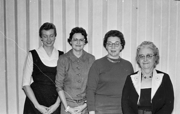 Group portrait of four members of the Insurance Women of Madison who are planning a fall membership dinner. Left to right: Leota Schoenof, Helen Henrickson, Elnore Hayes, Poynette and Delma McKee.