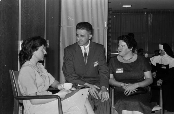 Three former German nationals attend a coffee hour for new US citizens hosted by Lawyers' Wives of Dane County. Left to right: Gertrude Miller and John and Hermoine Lengdobler.