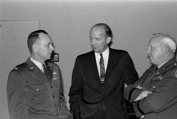 Three men stand and chat at the Air Power banquet held at the Wisconsin Memorial Union. Some of the military officers and civilian officials in attendance are shown, left to right: Col. John Weltman, Mayor Ivan Nestingen, and Maj. Ralph Olson.
