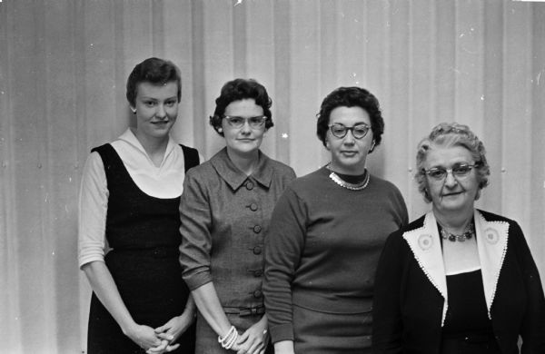 Four founding members of Insurance Women of Madison pose at General Casualty Insurance Company. They are, left to right: Leota Schoenoff, Helen Hendrickson, Elnora Hayes, and Delma McKee. All women employed in insurance work are eligible for membership.