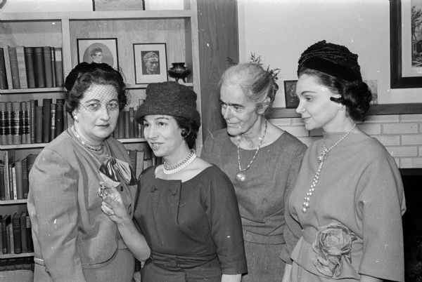 Group portrait of members of the Madison women's committee for State of Israel Bonds. Left to right are Evelyn Minkoff, Jan Peerce, Elizabeth Raushenbush, and Sherry Goldstein. Mrs. Peerce, who is the national chairman of the women's division, holds a Star of Israel pin that is awarded to women who purchase or sell a million dollars worth of bonds.