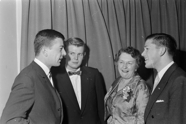 Three Brittingham scholars at the University of Wisconsin chat with Constance Elvehjem. They include, left to right: Yves Struye from Brussels, Belgium; Jon Jonsson from Reykjavik, Iceland; Mrs. Elvehjem; and Klas Stenstrom from Djursholm, Sweden. Thomas Brittingham Jr. died April 16, 1960. The Brittingham Scholars program, founded in 1953 continued through 1962.