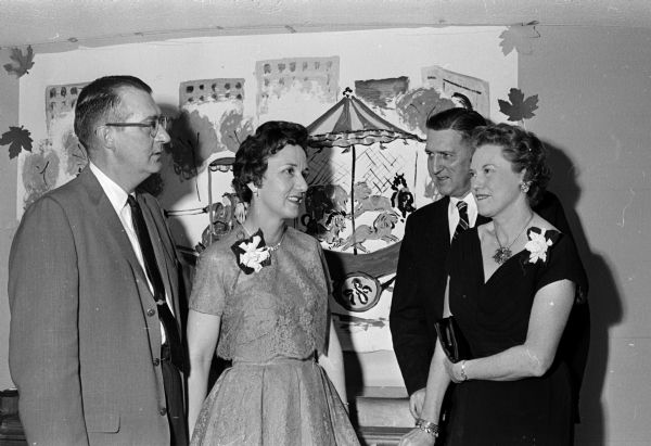 "Carnival!" was the theme for the annual benefit dinner dance of the Woman's Auxiliary to the Dane County Medical Society. Attendees shown, left to right, include: Dr. Charles and Eleanore Stoops, and Dr. Kenneth and Katherine Lemmer.