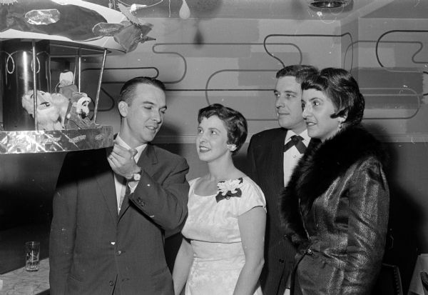 Admiring decorations at the benefit dinner dance of the Woman's Auxiliary to the Dane County Medical Society are, left to right: Dr. James and Jean Moore, and Dr. J.D. and Beatrice Kabler.