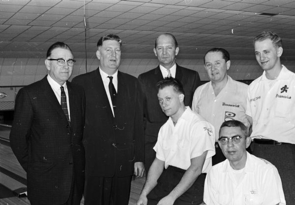 Present for the grand opening of Burr Oaks Bowl are, standing, left to right: John Iverson, Connie Schwoegler, and Mayor Ivan Nestingen. At the right are four bowlers who participated in a special doubles match. Seated are: Nick Gampietro and Gil Fischl of Madison. Standing are Ned Day and Wayne Zahn of Milwaukee.