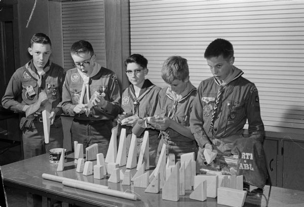 Scouts from Middleton Troop 40 sand wooden blocks to give to the pediatric section of Madison General Hospital. The wood was donated by Fish Lumber Co., Middleton.  Left to right are: Don Campbell, Paul Gillings, David Gillings, John Fordyce, and Jerry Griswold.