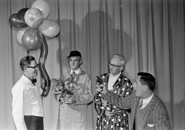 Scene from "Here We Go Again", an amateur variety show put on as entertainment for the 1961 Twelfth Night party at Nakoma School. Four cast members of the variety show are left to right: Charles Rauschenberger, Stanley Caldwell, William Graham, and Erin Karp.