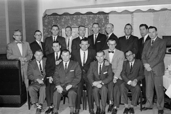 Group portrait of 17 insurance men, each who have been named by his agency as "Man of the Year." They are at the Madison Association of General Agents and Life Managers annual awards meeting.