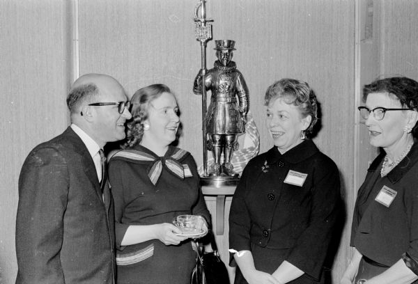 Four people attending the Wisconsin State Historical Society's reception in the Beefeaters' room of the Memorial Union are, left to right, John Jacques, business manager of the Society; Betty Jacques; Pauline Wilcox, wife of the Society's business manager; and Alice Smith, the Society's director of research.