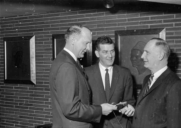 Wendell Phillips, City Council president, presents ex-mayor Ivan Nestingen with a key to the city telling him he would always be welcome in Madison. President John F. Kennedy had appointed Nestingen under-secretary of health, education and welfare.