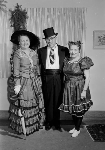 Three participants in the fourth annual public Fun-O-Rama pose for a group portrait at the Catholic Community Center. Helen Fagan (left) and Larry Henry (center) will act as hostess and maitre d'hotel, and Harriet Germann (right) will be one of the entertainers. The event is sponsored by Cooperators of Opus Dei (the women's branch of Opus Dei).
