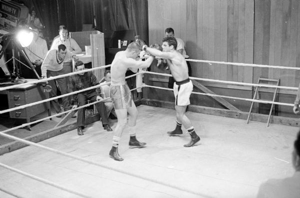 Bobby Christopherson, left, and Jerry Turner mix it up in their exhibition bout that featured Saturday's Madison Golden Globes boxing tournament finals.