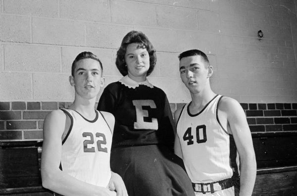Cheerleader Patricia Sweeney will be cheering on her brother, Dennis, left, a sophomore, and her cousin, Mike, a senior, when Edgewood High School's basketball team plays in the state Catholic tournament in Milwaukee.