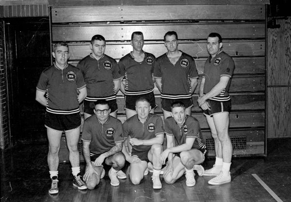 Group portrait of the Tipler Transfer basketball team after winning their fourth Madison Recreation Department city meet title in five years. Pictured kneeling in front are: Jack Vahradian, Paul Nelson, and Hap Johnson. Standing in back are: Keith Tipler, Al Imm, Bob Ziech, Dale Bossenberry, and Gene Orvis.