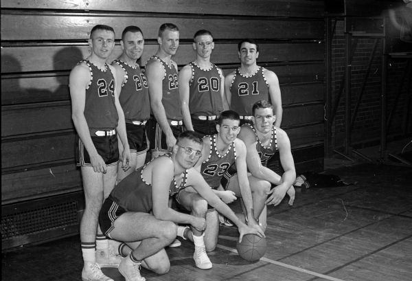 Group portrait of members of the Eggimann Motors #1 basketball team, runner-up in Madison city basketball tournament. Shown in the front row, left to right, are: Bill Workman, Howie Mazur, and Fritz Kruger. Shown in the back row, left to right, are: Ray Kelliher, Bob Haukedahl, Bob Bond, Roger Wiebe, and Ed Chobanian.