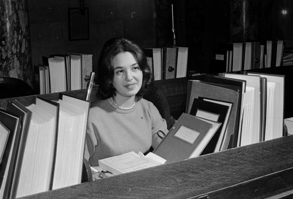 Ann Garfinkle sits at a desk in the Wisconsin Assembly chamber as she plays the role of a United States Senator during the annual mock senate event sponsored by several University of Wisconsin student groups.