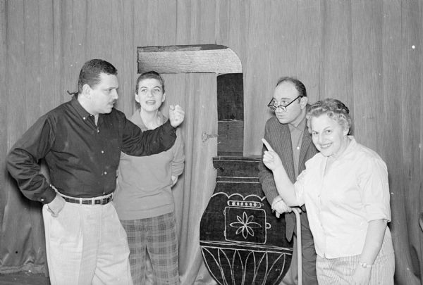 The Beth Israel Players will present an original musical comedy, "Room for One More" in the auditorium of Beth Israel Center. Shown in a scene from the play are, left to right: Bernard Seltzer, Jean Seltzer, Frank Mann, and Ella Hirschfeld. The play is directed by Alfred Kaufman and Charlotte Schwartz with Jerry Blake as musical director.