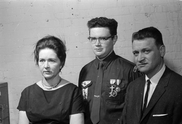 Jerry Lorenz, junior at Edgewood High School and member of Explorer Post 34 at St. Bernard's Catholic Church, earns his Eagle Scout badge. Shown (L-R) are Mrs. Edward Lorenz, Jerry Lorenz, and Mr. Edward Lorenz.