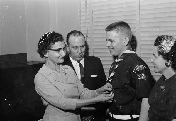 Roger Boeker, Scout Explorer and University of Wisconsin freshman, is presented the Eagle Scout award. Shown (L-R) are: Mrs. Arthur Boeker, aunt; Mr. Leonard Boeker, father; Scout Boeker; and Mrs. Leonard Boeker, mother.