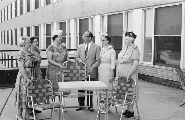 The Wisconsin Department of the Disabled America Veterans Auxiliary has donated $500 worth of lawn furniture to the Madison Veterans Administration Hospital. Five representatives of the group are shown with Dr. A.M. Gottlieb, manager of the hospital, and samples of the furniture. Members of the auxiliary are left to right; Mrs. Henry Nehmer, Milwaukee; Mrs. Harold Green, Kalamazoo, Michigan;  Carol Bussian, Madison; Mrs. Paul Muetze, La Crosse; and Violet Hansen, Madison.  
