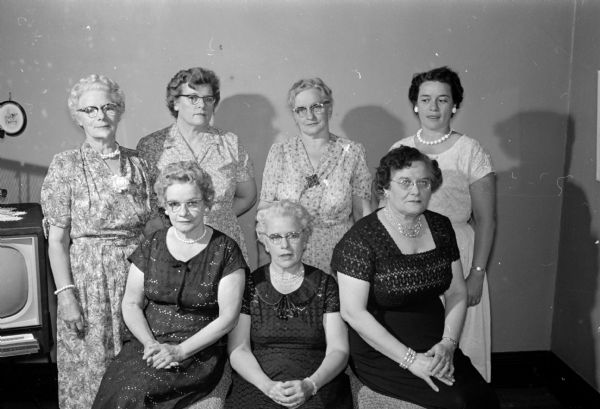 Seven Dosch sisters, all whom were former teachers in Wisconsin, hold a  reunion in Madison at 509 W. Dayton Street. Shown seated (L-R) are: Beulah Dosch Elliott, LaCrosse; Esther Dosch Perkins, Neillsville; and Ruth Dosch Evans, Madison, who hosted the reunion. Shown standing (L-R) are: Nellie Dosch Knudson, Cobb; Louise Dosch Boode, Madison; Bertha Dosch Bradbury, Fennimore, and Carolyn Dosch Cooper, Madison.