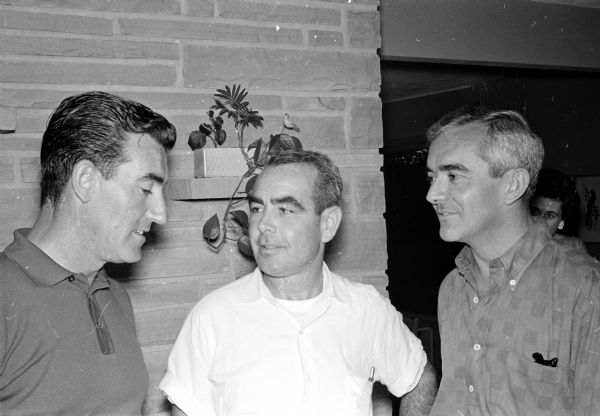 Promoters of understanding between neighboring countries and of labor problems within countries are shown conversing. Charles Maquire (center), is team manager from the U.S. Dept. of Labor; Jos Sueiro (left) and Eduardo Danino (right) are interpreters.