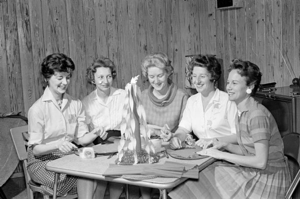 The annual dinner-dance of the Who's New Club will be held at the Welch's Embers. Committee members who are making maypole decorations include, from left to right: Janice Browning, Bernice Swenson, Joan Watts, Nan Farrar and Mrs. Robert Gilbert.