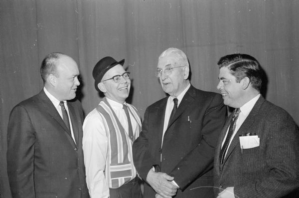 Rep. Melvin Laird (R-Marshfield), left, talks with three Republicans who were in the Republi-Capers show. Left to right are: Marland Gullickson, a member of the state GOP headquarters who provided musical entertainment; Senator Jess Miller (R-Richland Center) who was in a skit; and Assemblyman J. Curtis McKay (R-Mequon) who sang and was in a minstrel act.