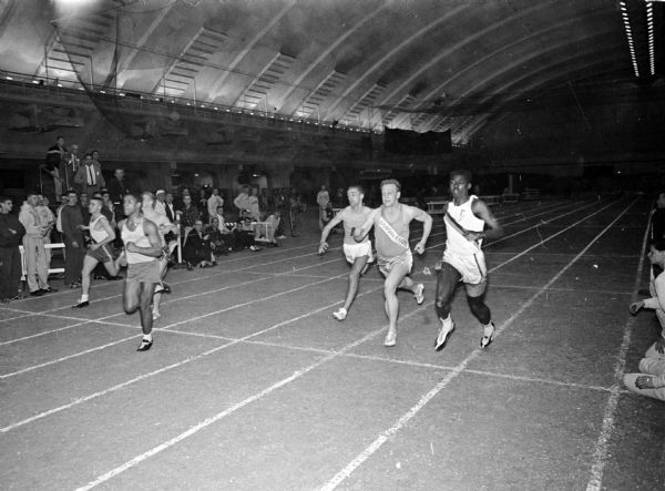 Madison East High School sprinter Mike Werner wins the 60 yard dash at the Madison West Relays held at the Camp Randall Memorial building.
Shown left to right with order of finish are Paul Fischer, West Bend (3); Rod Putnam, Madison West (4); Mike Werner, Madison East (1); Jerry Laack, Sheboygan North (6); Mike Ryan, Monona Grove (5); and Rufus Pearson, Freeport, IL (2).