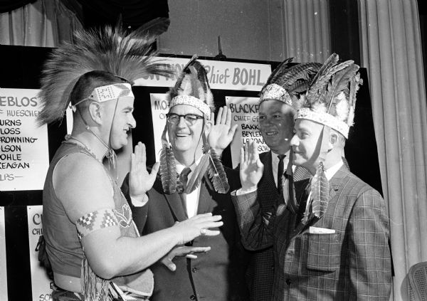 Chief No-Ha-Nutch'Ka,left, who is actually Jack Grey, head of public relations for Wisconsin Dells, gives Chamber of Commerce members tips on how to gain members during its annual membership drive. Pictured left to right are Jack Grey; Dorsey Botham, Chamber president; Collins Ferris, winner of the membership Spark Plug award for 1959-60; and Ray Bohl, membership chairman.