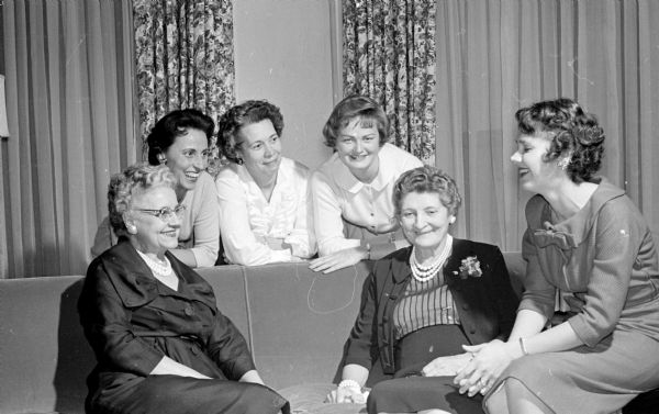 Alpha Xi Delta sorority committee members complete plans for their State Day luncheon. Seated in front left to right: Mrs. John Wise, Alma Runge, and Martha Dries. Back row left to right:  Mary Feifarek, Elizabeth Kurtenacker, and Christine Hughes.