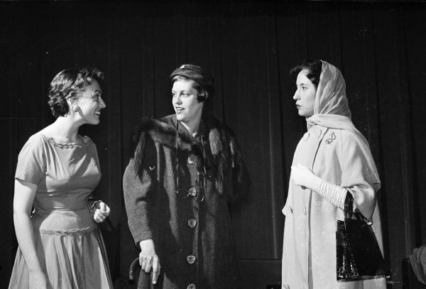 Members of the cast of a skit to be presented by the UW Dames Club drama group at the Wisconsin Union Theater stand together in costume.  Left to right: Dixie Stetson, Mrs. Allen K. Herd, and Arlene Ellingson.