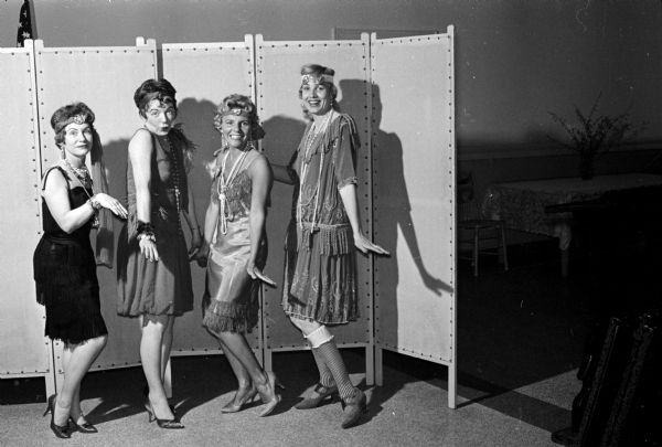 Group portrait of four members of the "Roaring '20's" portion of the Junior Woman's Club's original production which is being presented to a number of organizations. This group portrait is at the Masonic temple prior to entertaining the wives of Scottish Rite members. Shown are June Gara. Mary Genn, Shirley Haase, and Helen Graham.