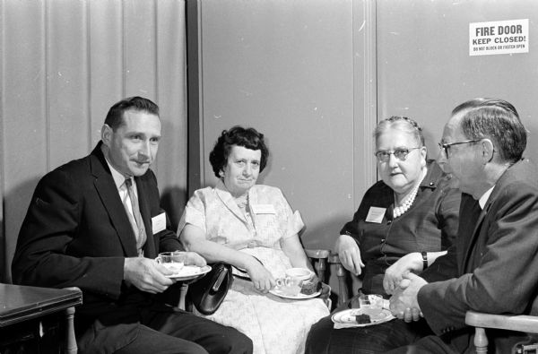 Seventy-two University of Wisconsin Hospital employees with long service records are honored at a party in connection with National Hospital Week. Honored for 15 years of service shown, from left, are: John Wake, Marie E. Kavanaugh, Mrs. Maude M. Kilen, and Homer Montague.