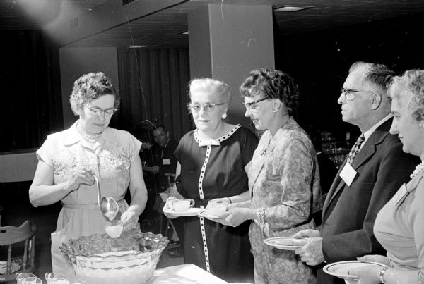 Seventy-two University of Wisconsin Hospital employees with long service records are honored at a party in connection with National Hospital Week. Shown from left are: Mrs. Anton B. Littel, Mrs. Lorenz H. Potter, Mrs. R.L. Kulzick, Louis Mutoli, and Alvira C. Mergen.