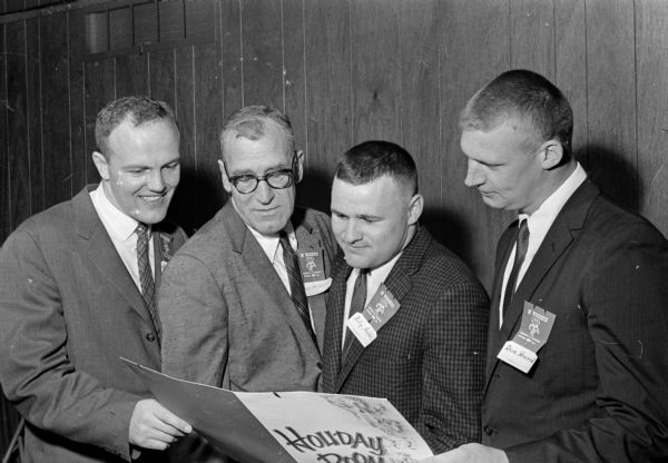 The W Club banquet is held at Holiday Inn Motel to honor University of Wisconsin alumni football players prior to the spring football game. 
Shown from left are: Jim Reinke; Ivan B. Williamson, athletic director; Bill Hobbs; and Dave Howard.